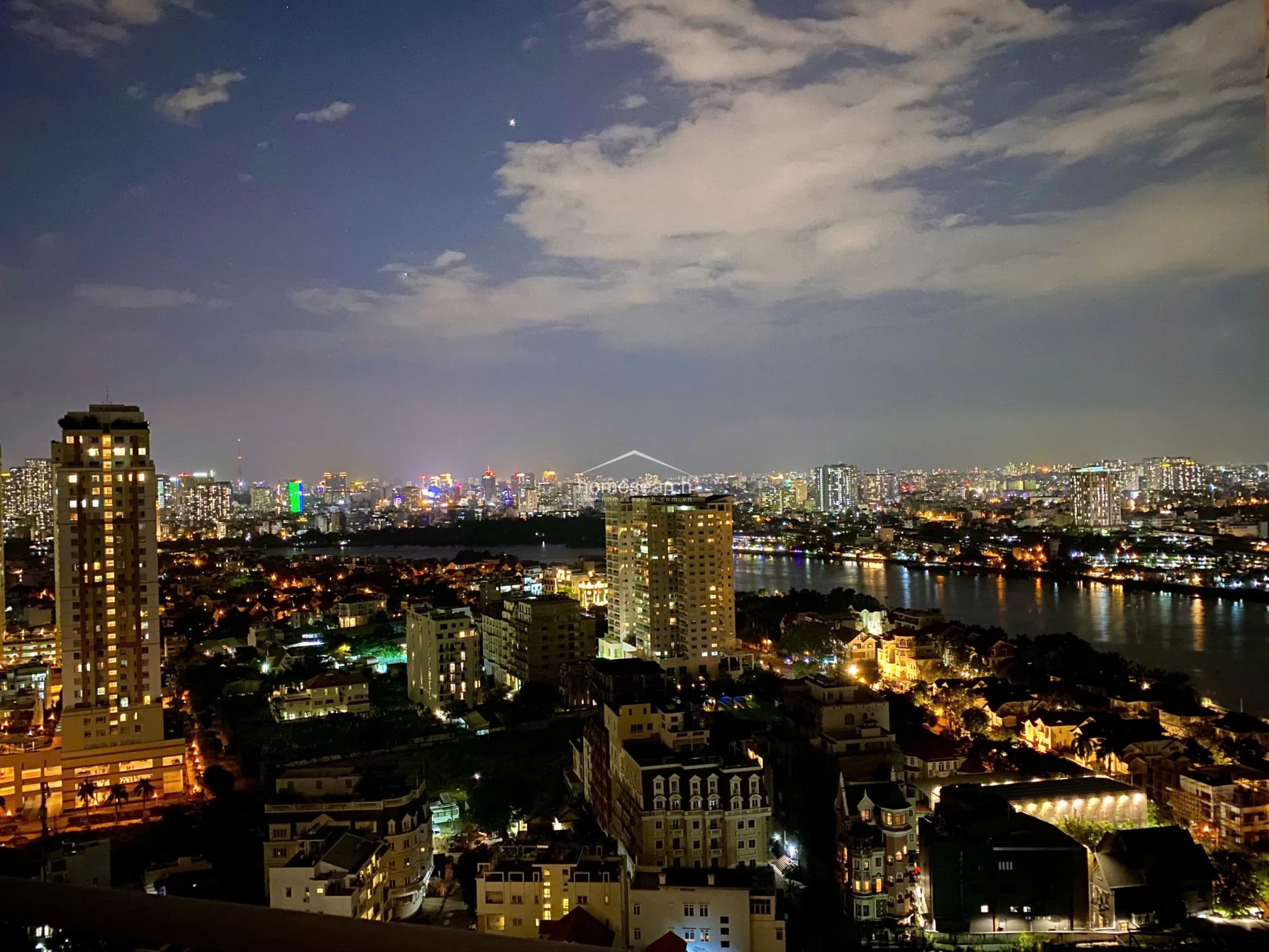 This nighttime view showcases the same cityscape transformed by urban lighting, emphasizing the property's dramatic and atmospheric appeal after dark. The clear sightlines over the river and illuminated high-rises provide a sophisticated, cosmopolitan backdrop for the residence.